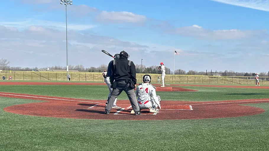 A group of people playing baseball on a field. 