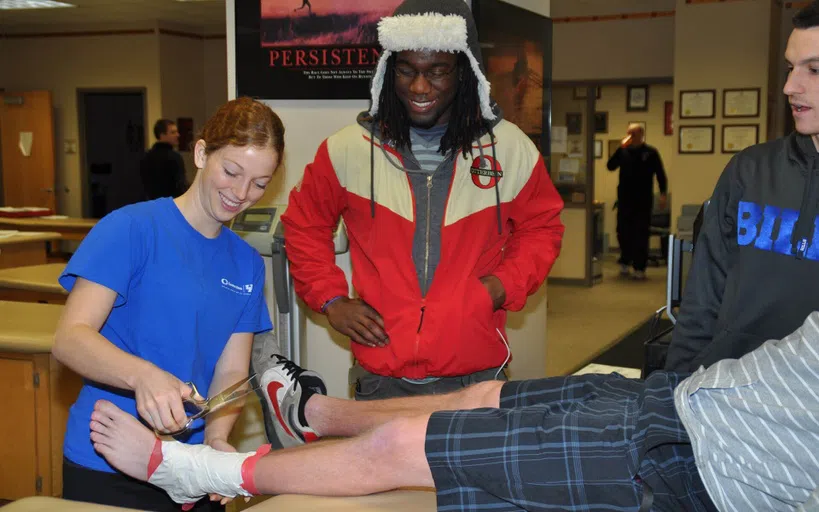 Group of people smiling and utilizing the rehab center.