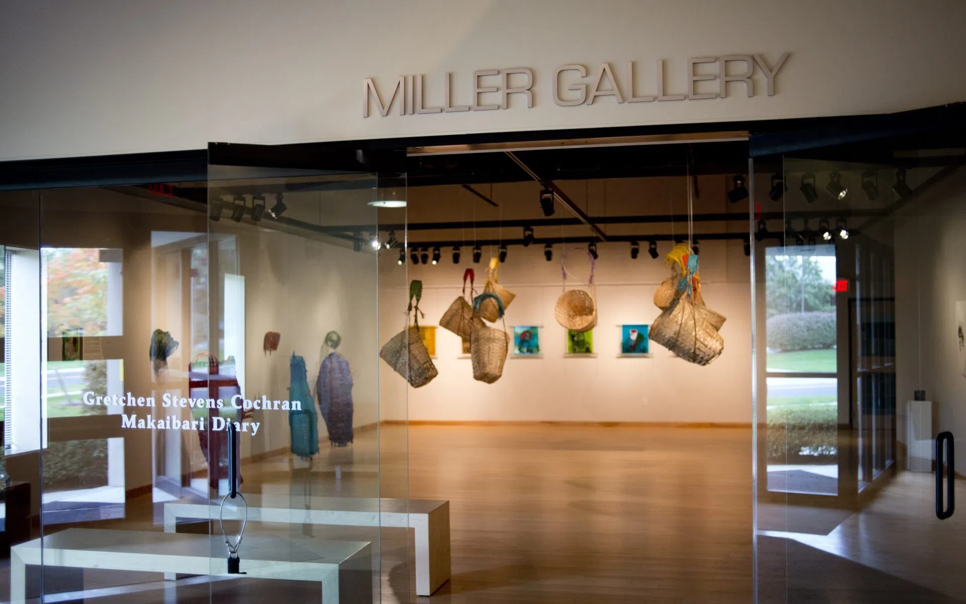 A gallery that is brightly lit with wooden floors. It reads "Miller Gallery"