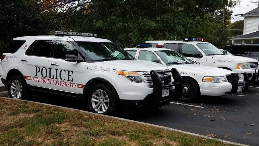 Three police vehicles are lined up: An SUV, a car, and another SUV. They are white with the word POLICE on the side.