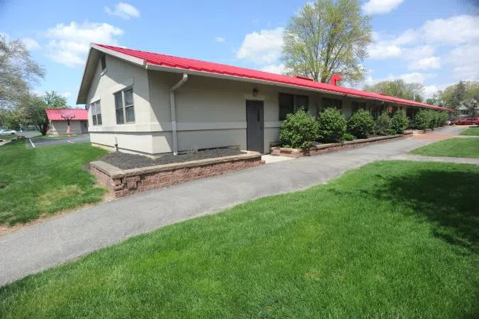 Main view of Garst Hall. A long one-story building surrounded by green areas.