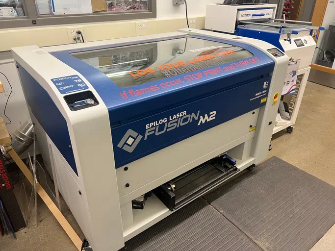 A blue and white laser cutting machine.