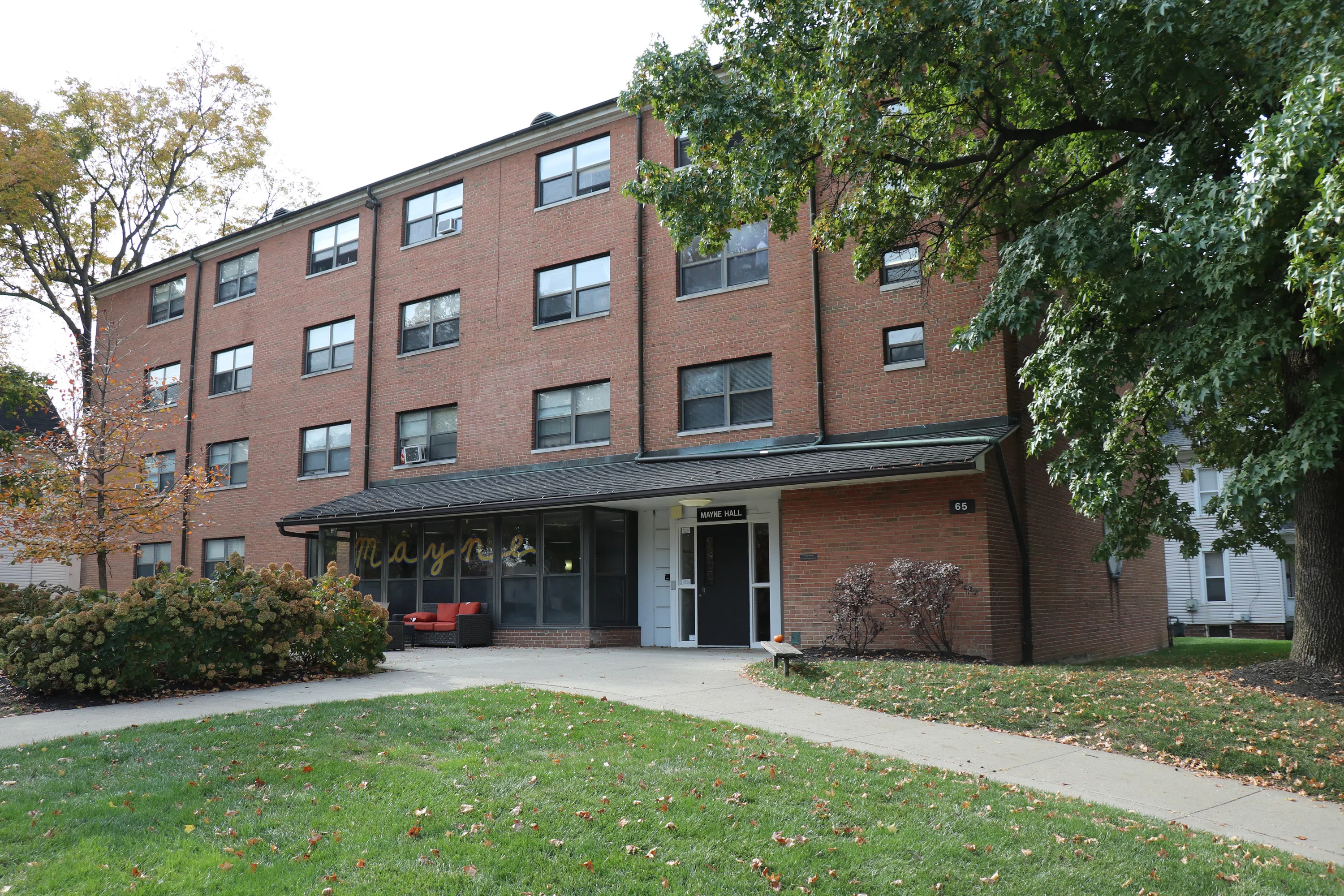Main view of Mayne Hall from the street. Four story brick building with a glass-enclosed foyer.