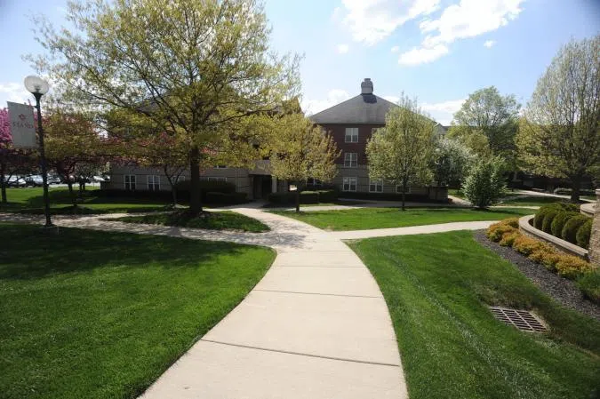 View of the grounds around The Commons on Park. Open green areas connected by paths.