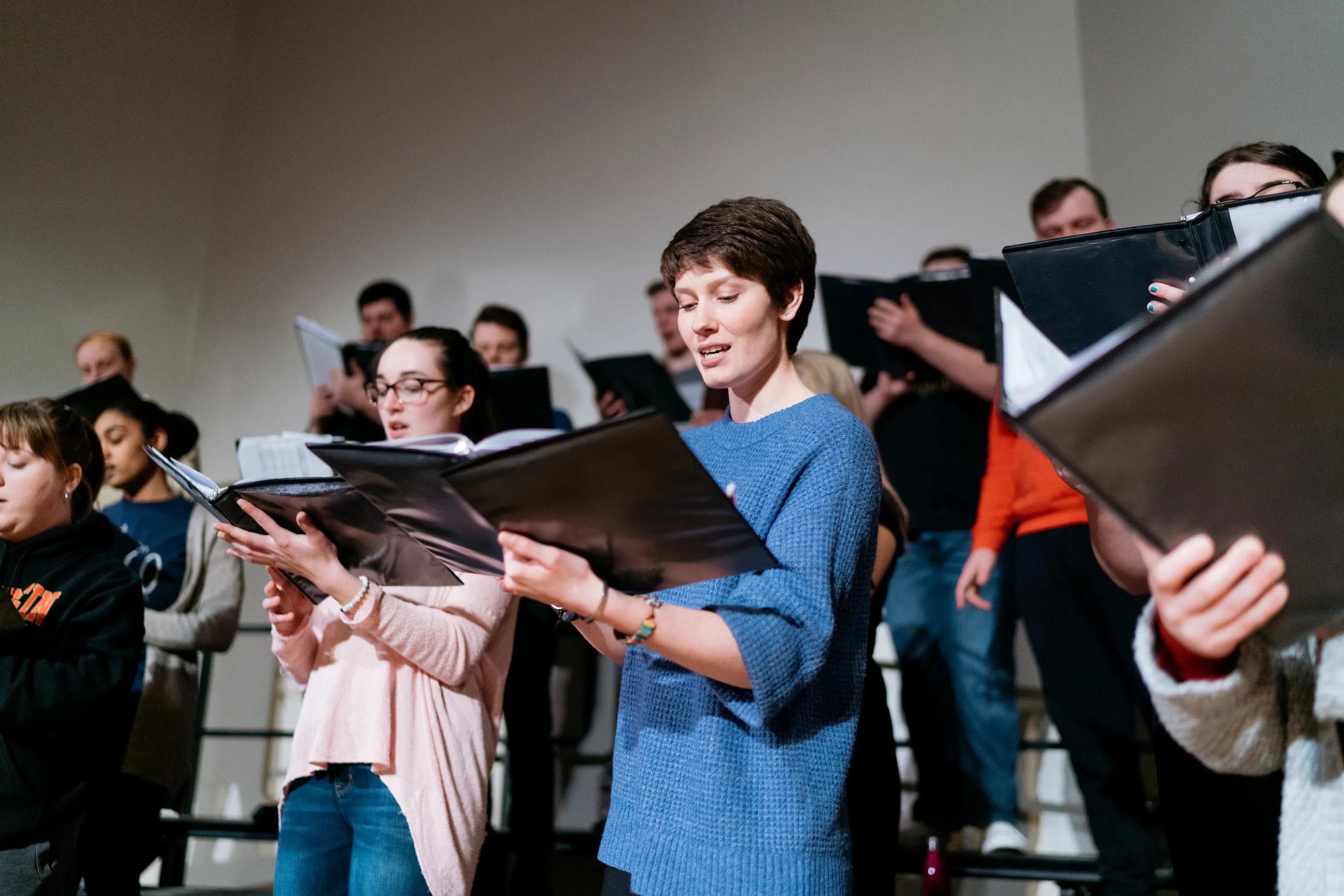 A group of people singing in a choir rehearsal