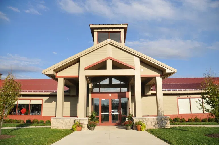 A beige building with red accents and roof.