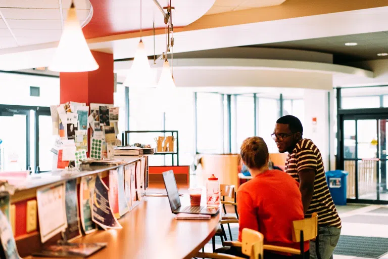 Two students chat together near the dining counter at the OtterBean.