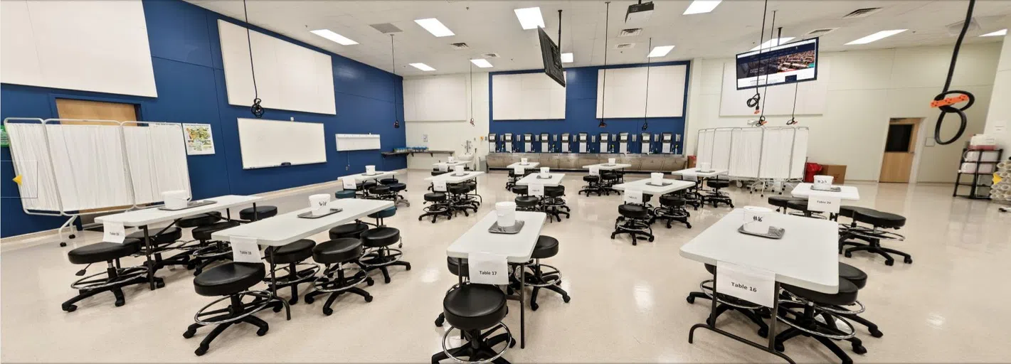 This is the anatomy lab at PCOM Georgia. There are stations with benches and chairs for students to work.