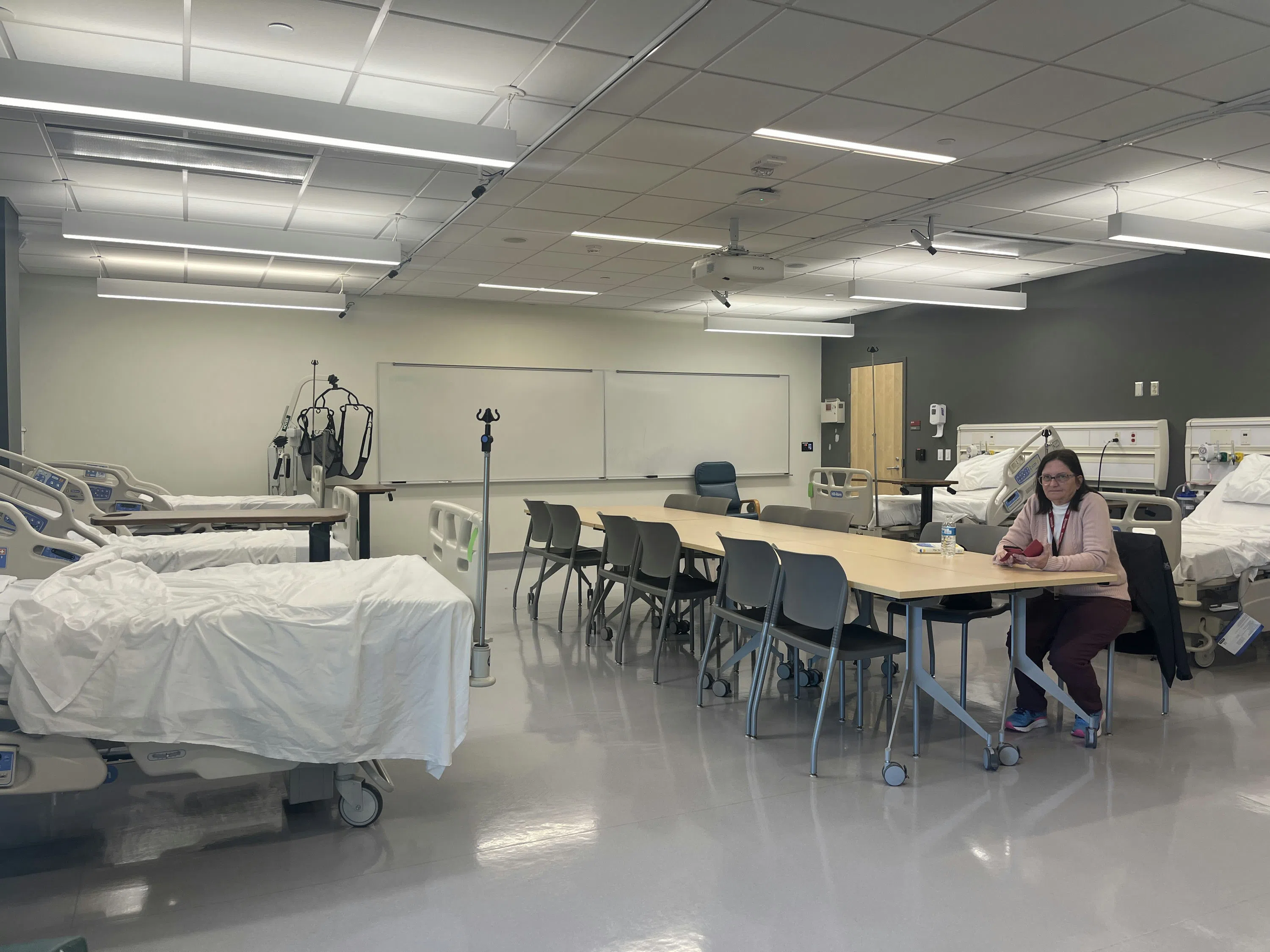 Person seated at desk located in the Nursing Lab.