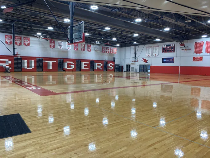 Rutgers signage is on a wall of the basketball court.