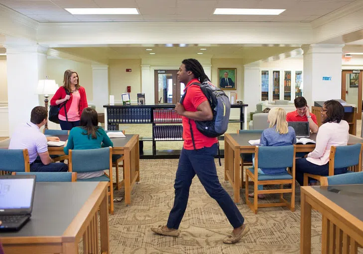 Student walks through the library.