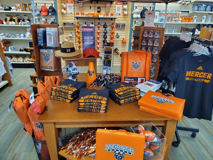 A table features Mercer U merchandise.