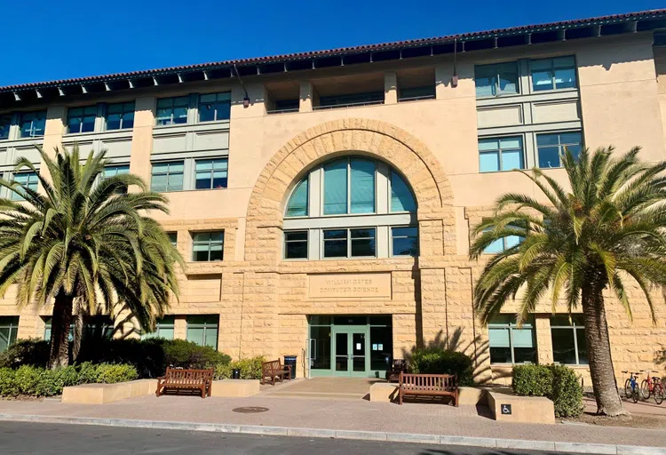 Palm trees and benches in front for four-story computer science building