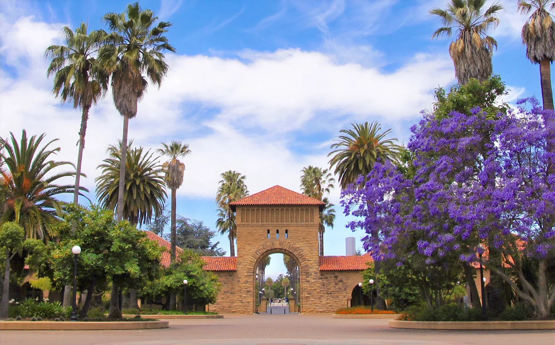 Sandstone archways that connect mission-style arcades surround trees in the courtyard of the Main Quad.