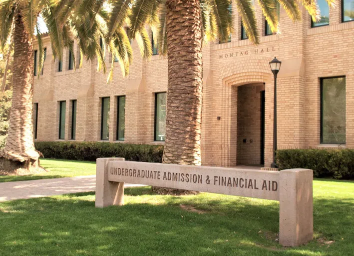 Brick building with palm trees and sign reading "Undergraduate Admission & Financial Aid"