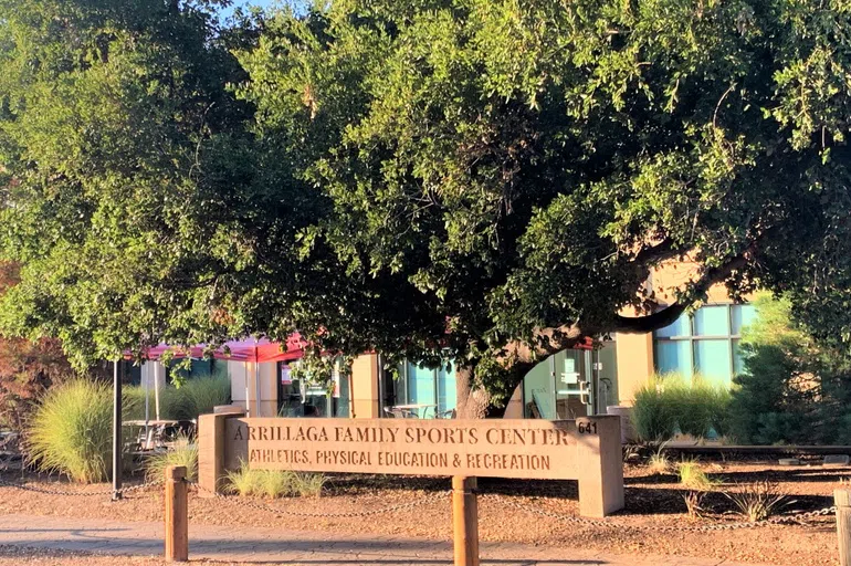 Building surrounded by trees with a stone sign indicating "Arrillage Family Sports Center - Athletics, Physical Education & Recreation)