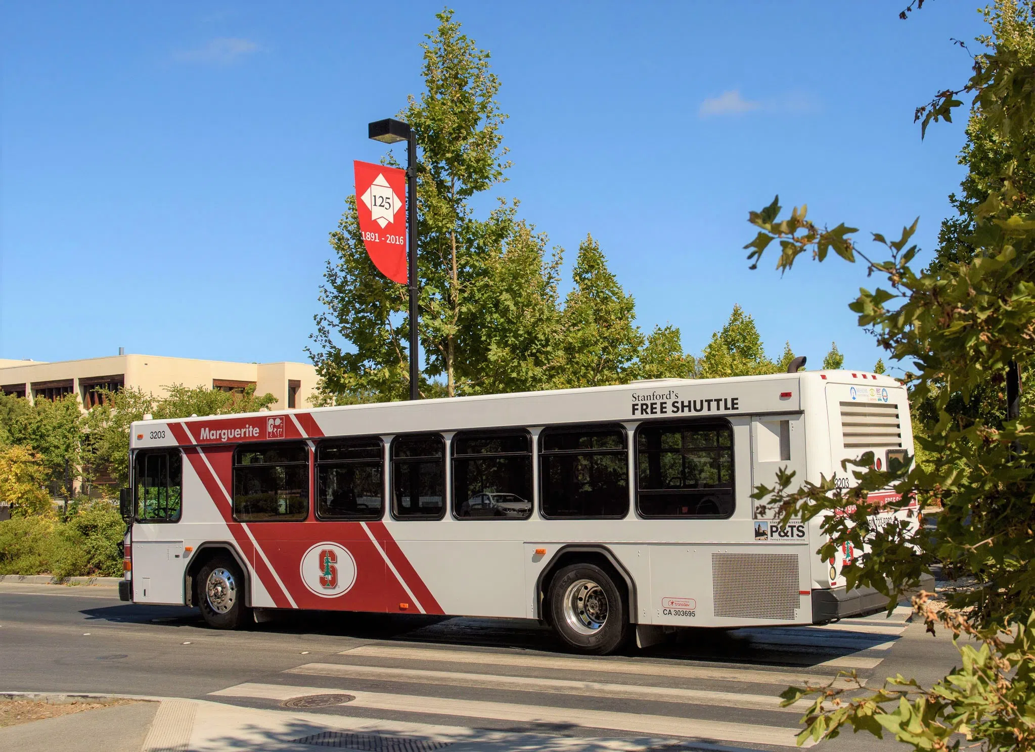 Large passenger bus with Stanford logo on the side