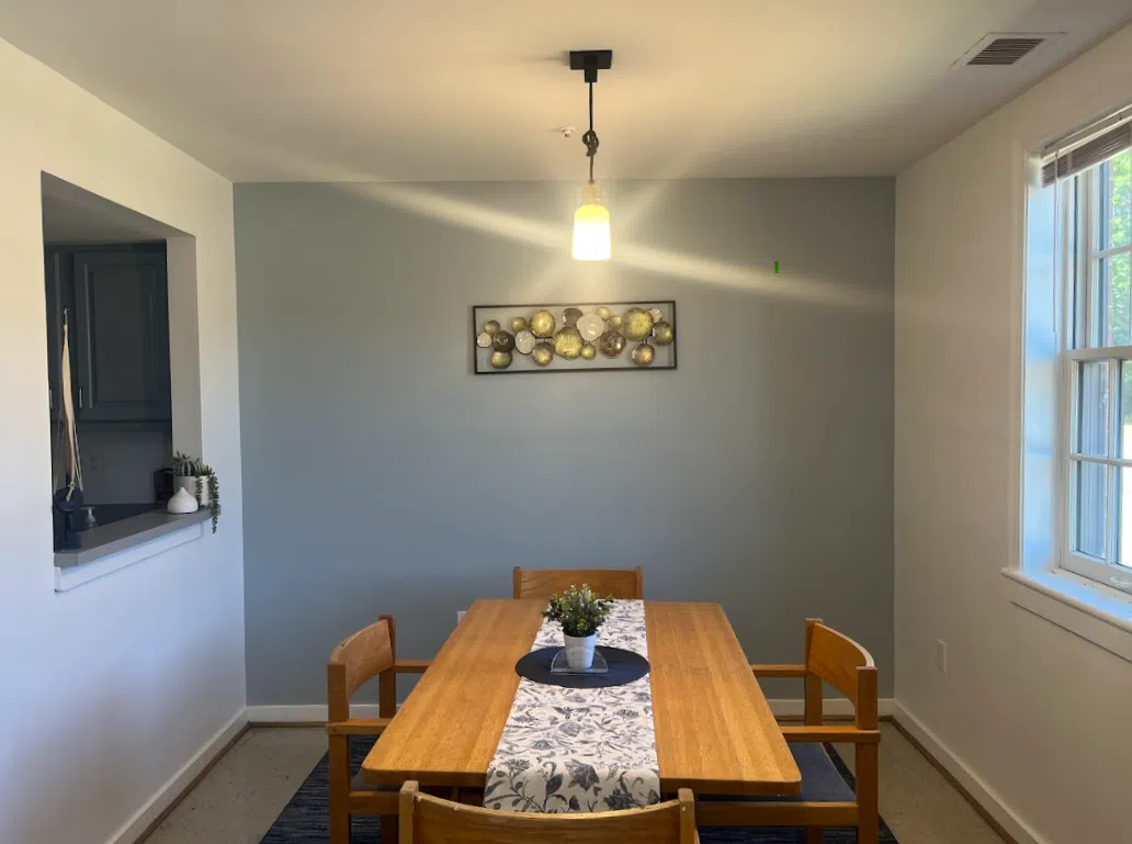 A townhouse dining room with a table and seating for four.