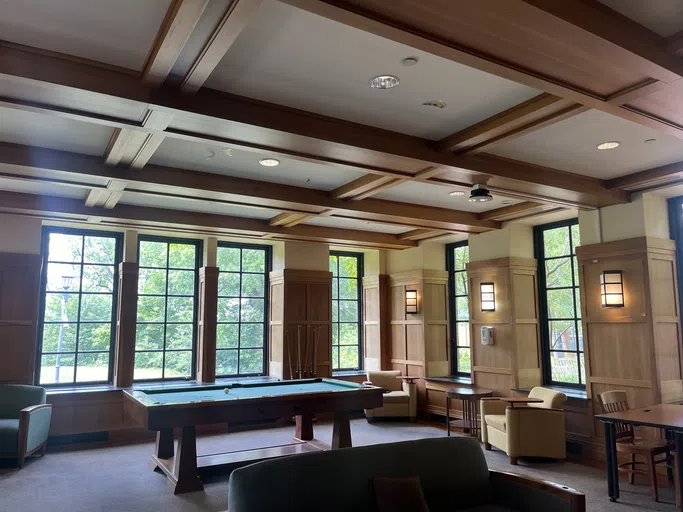 Lounge area featuring a pool table, comfortable seating, and lots of natural lighting.