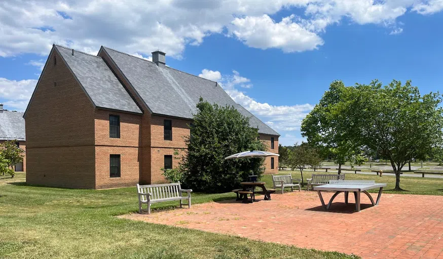 Outdoor seating and ping pong table outside of Waring Commons