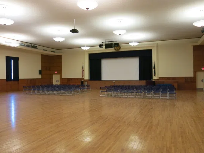 Chairs set up theater style in front of a stage in Buyer Auditorium