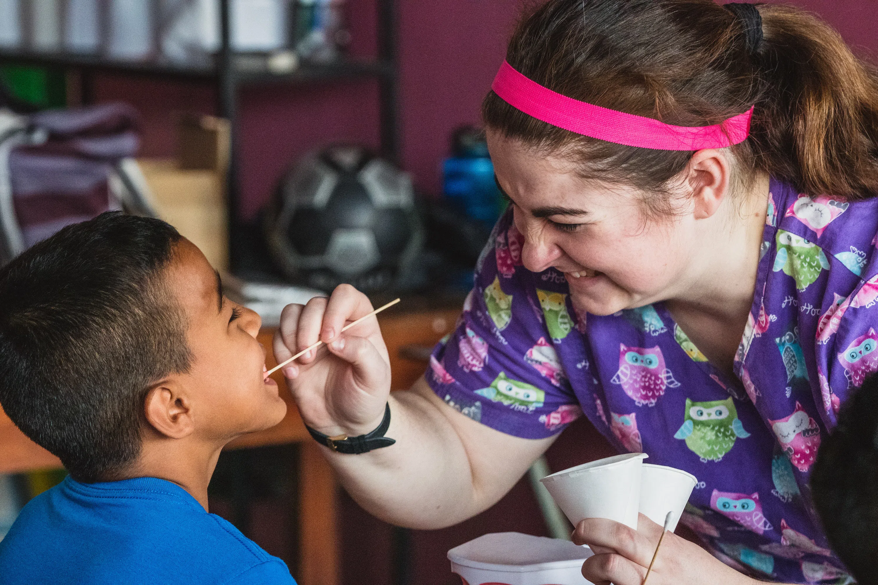 A WVU Student administering a check up on a child. 