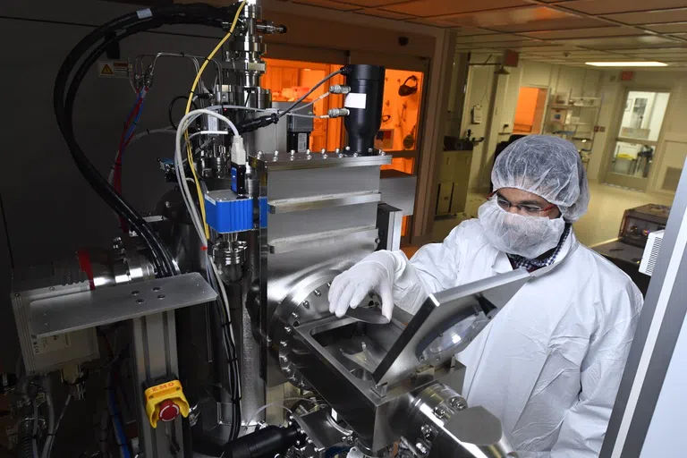 A student using equipment inside one of WVU's Clean Rooms 