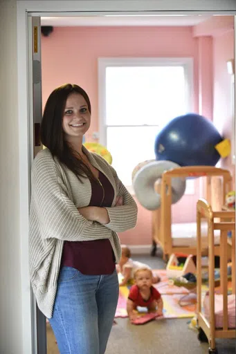 Student poses in front of a nursery.