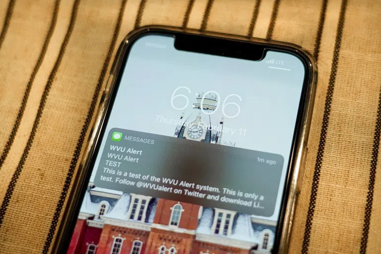 A photo of a phone receiving a WVU text alert. 