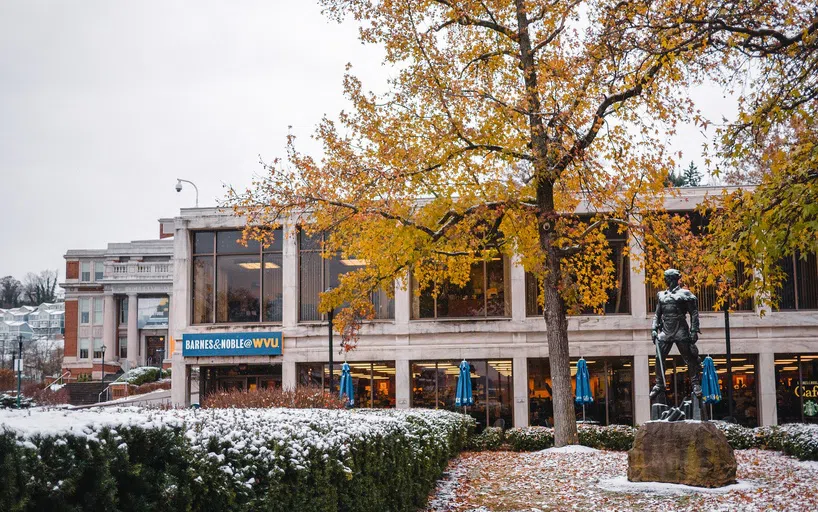 The image shows a snow flurried view of the exterior of the downtown Barnes and Noble Bookstore.