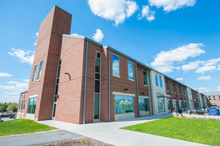 A sunny photo of the outside of the Health and Education Building 