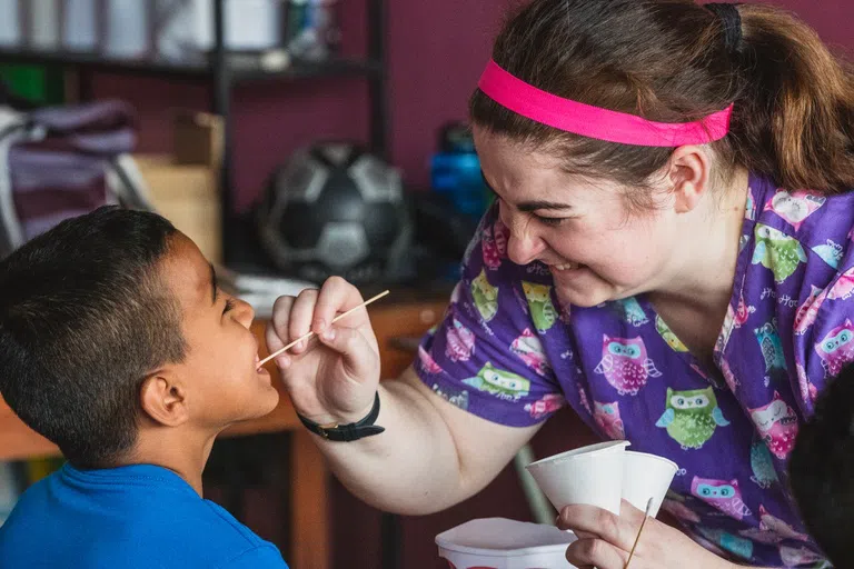 A WVU Student administering a check up on a child. 