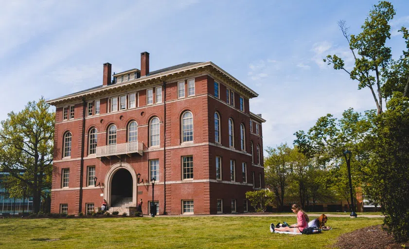 Students lay in the sun in front of Chitwood Hall 