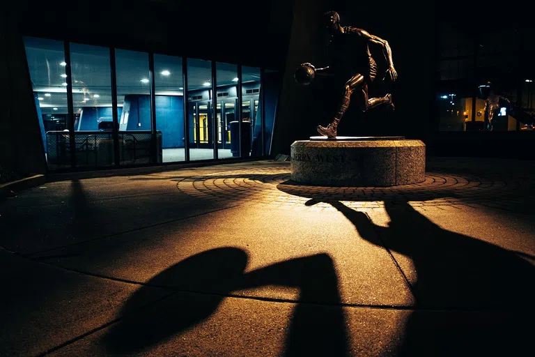 Night time shot of Jerry West statue in front of WVU coliseum. 