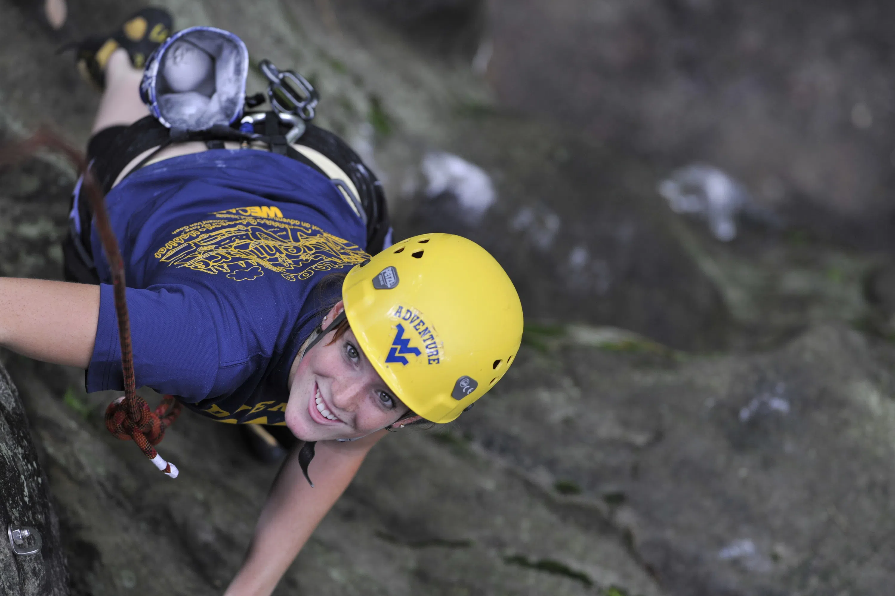 Student climbing rocks.