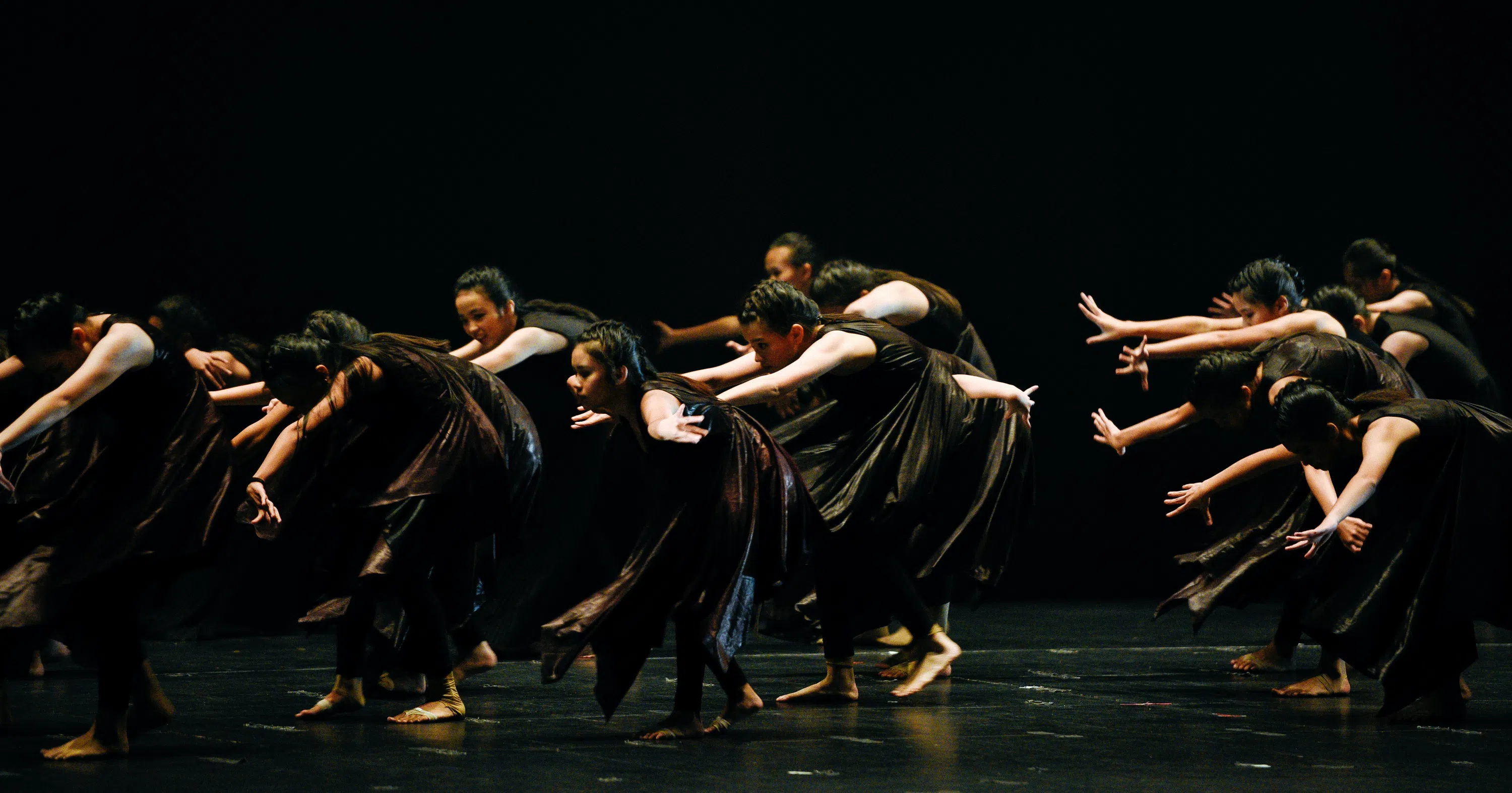 Group of people bowing down in a ballet move