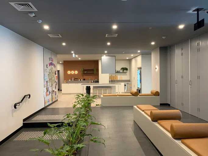 Lobby of residence hall with benches and desk