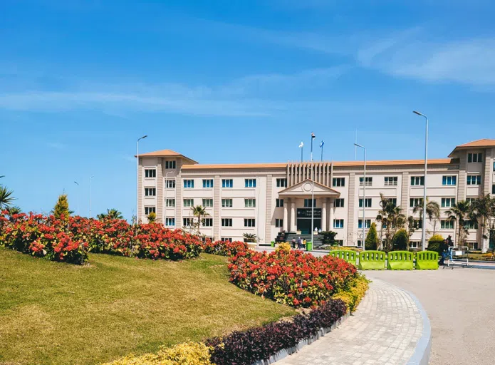 The W circle in the front of campus with flowers and green grass