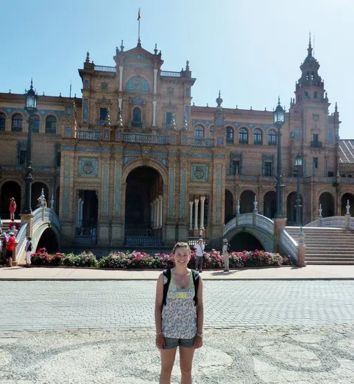 Student in a plaza in Seville, Spain with a backpack on