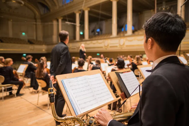 Orchestra playing on a stage with a conductor