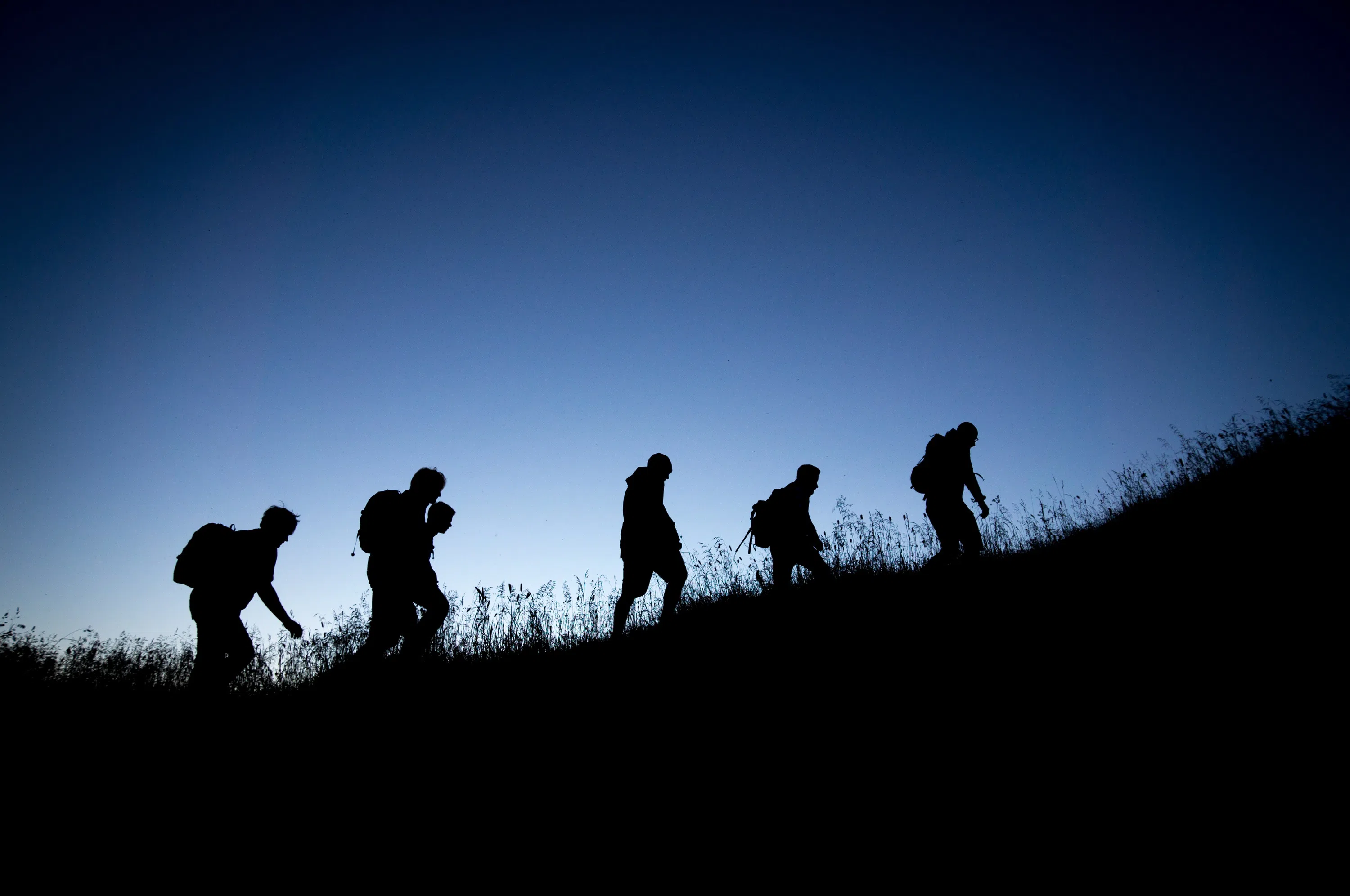 Student hiking in the early morning on the hill