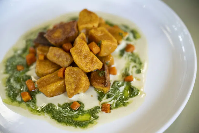  A plate of plant based nuggets served on greens.