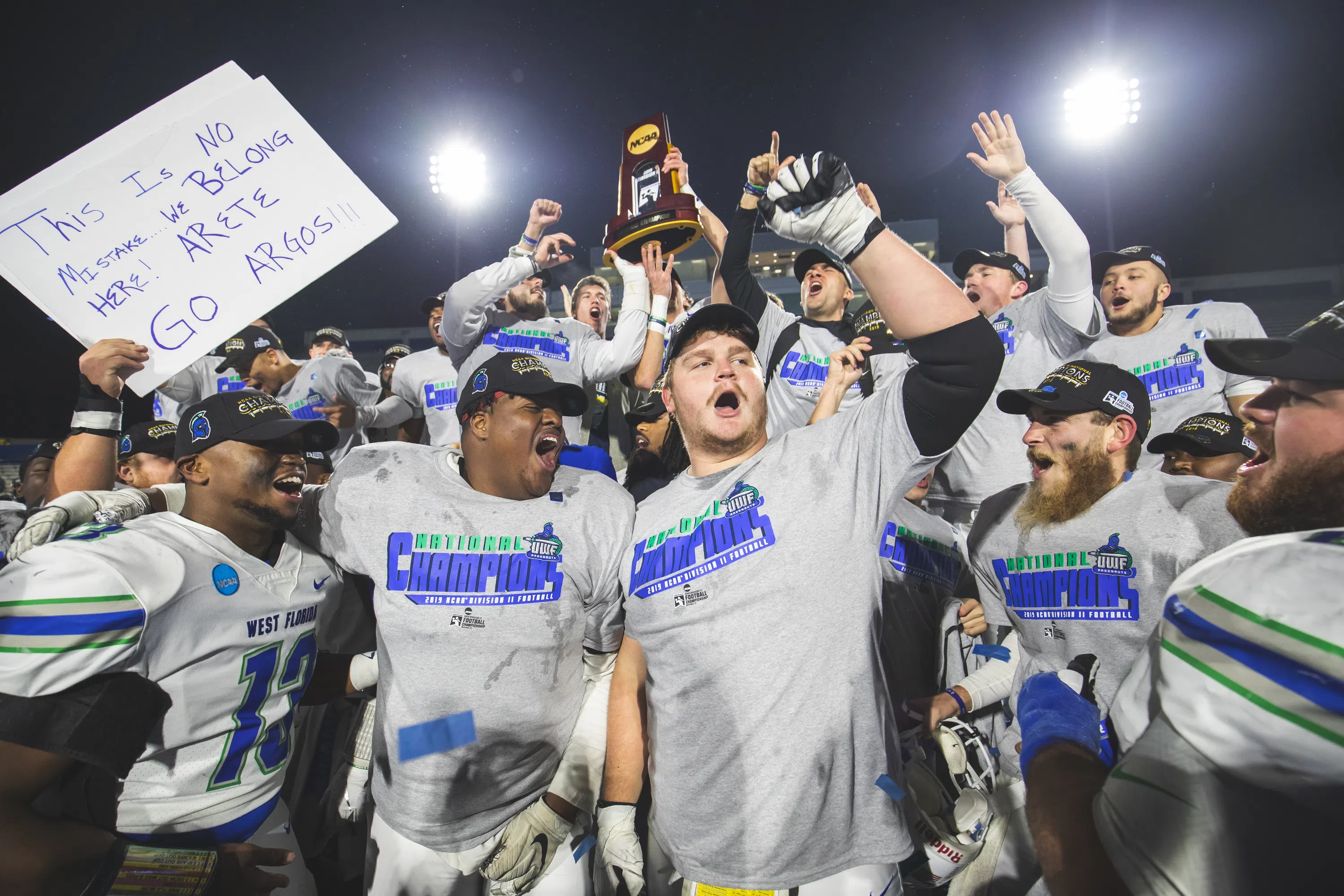 Football players celebrating championship on the field 