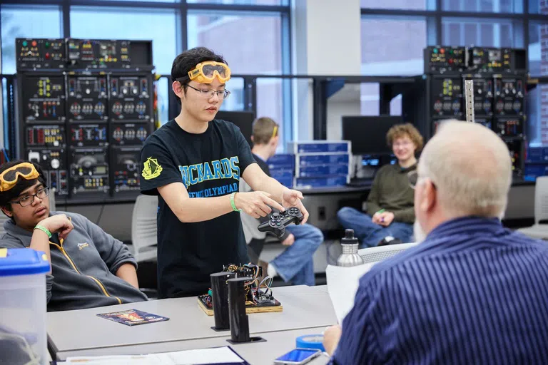 Student demonstrating computerized project for competition