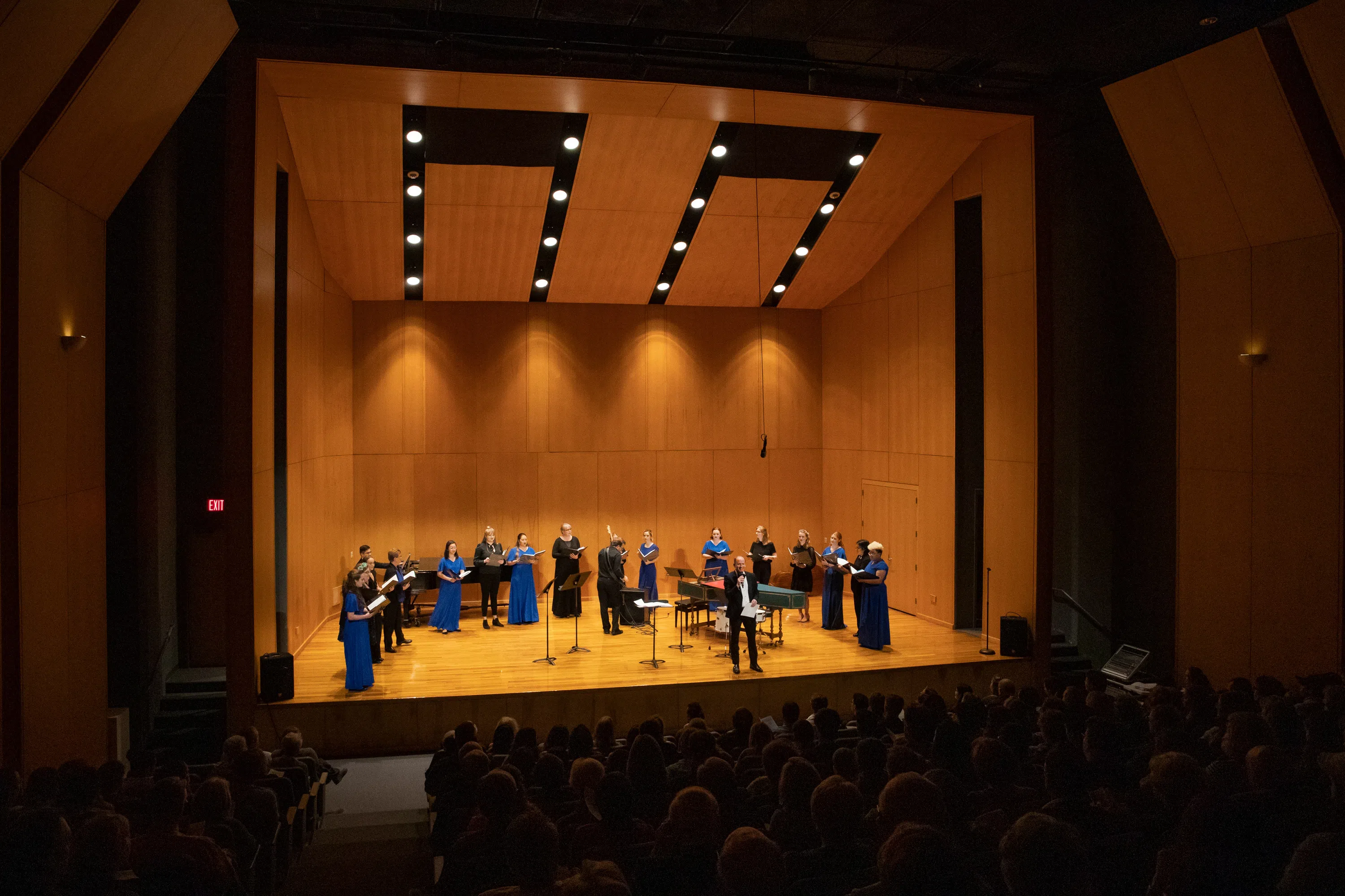 Singers performing on stage in the music hall