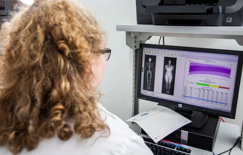 UWF students using the dexa machine in the Department of Movement Sciences and Health.