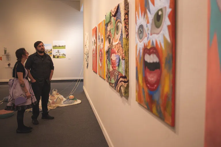 Two students viewing art in the Art Gallery.