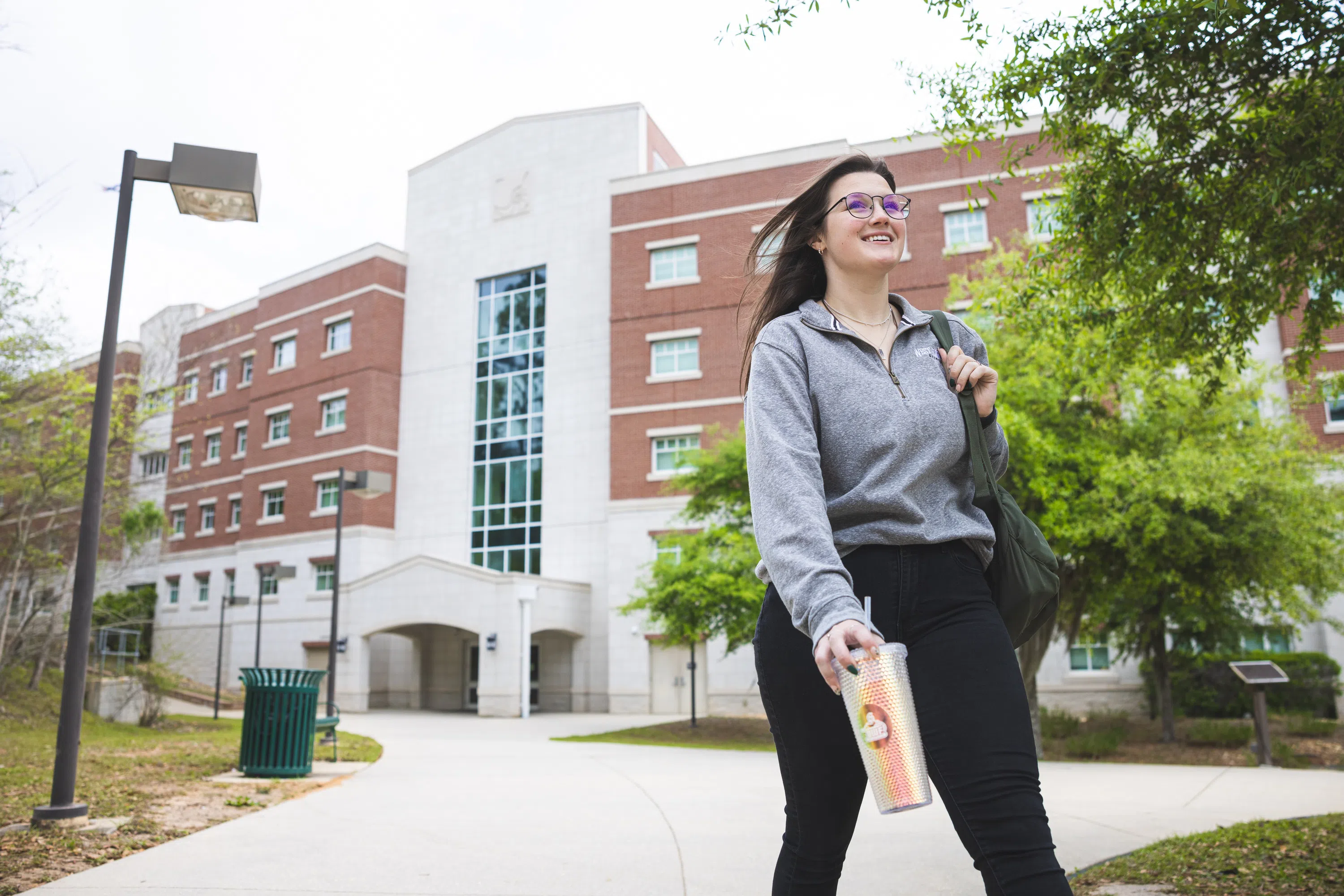 Female student walking outside Hertiage Hall