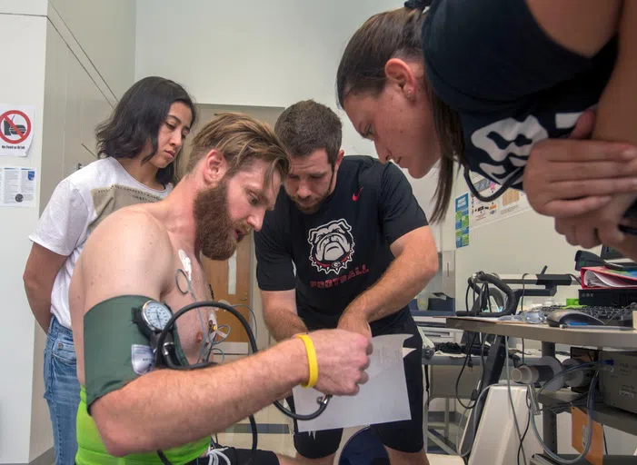 Student being connected to cardiac monitor.