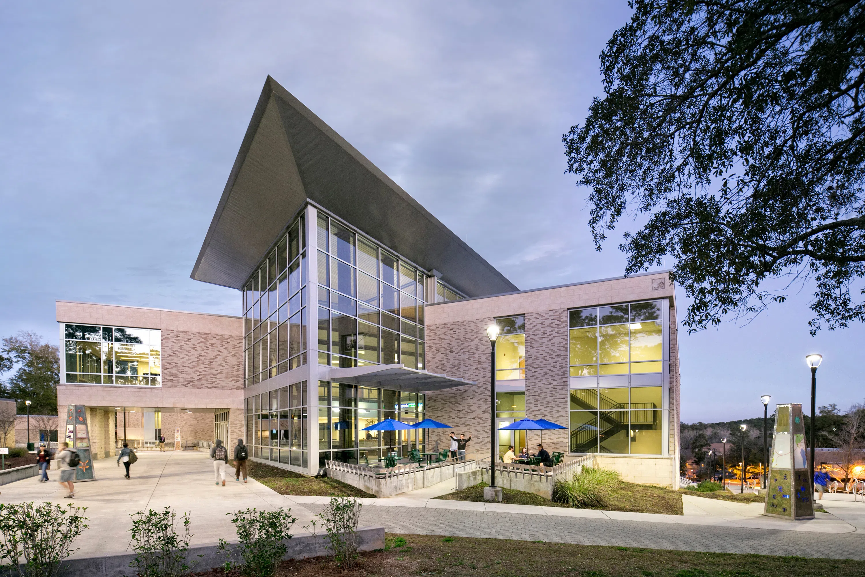 The exterior of the College of Business at dusk. 